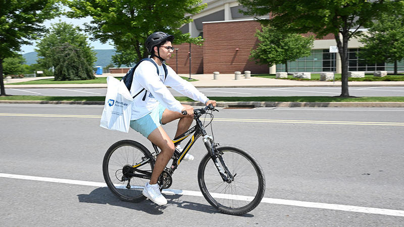 student biking past BJC