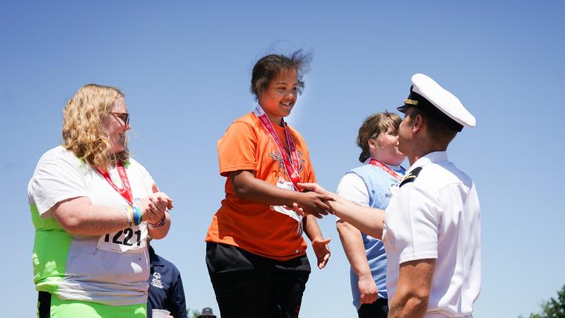 Special Olympics Athletes receiving medals at an award ceremony 