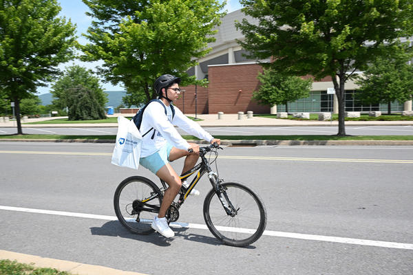 Student biking at the Bryce Jordan Center