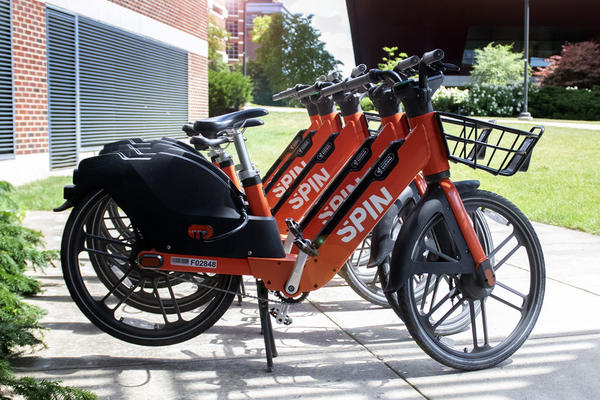 Spin e-bikes lined up and ready to rent