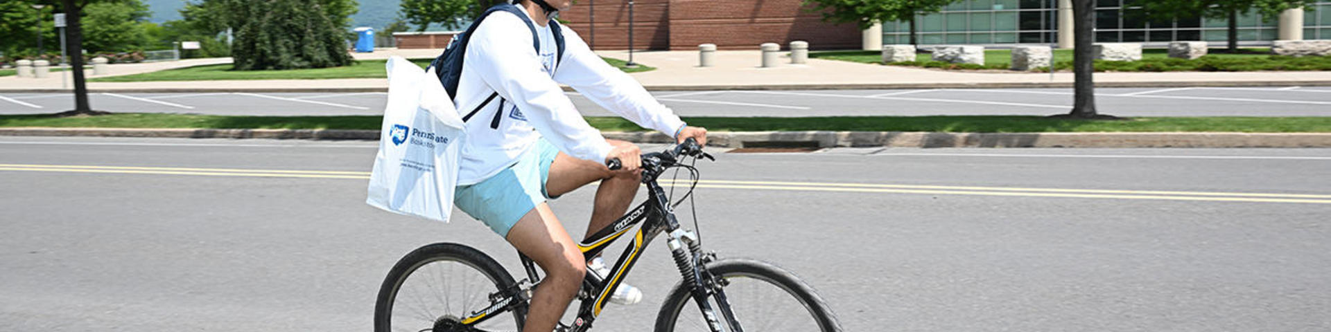 student biking past BJC