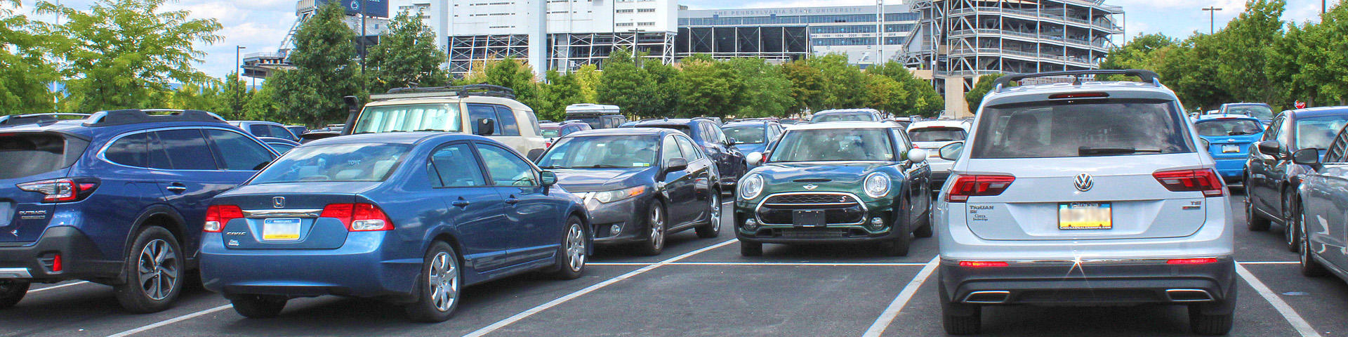 Cars in a parking lot in front of Beaver Stadium