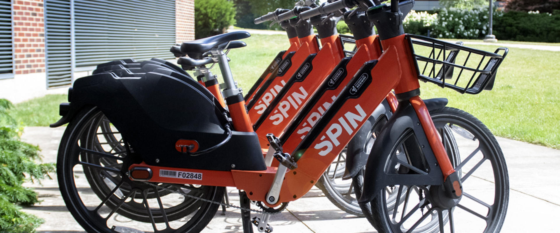 Spin e-bikes lined up and ready to rent