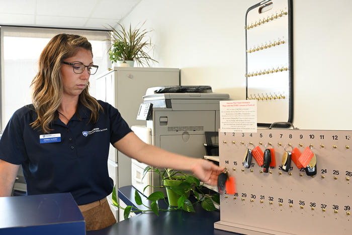 Fleet employee reaching for vehicle keys