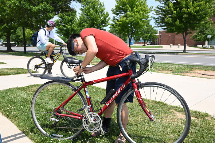 Cyclist inspecting a bike seat 